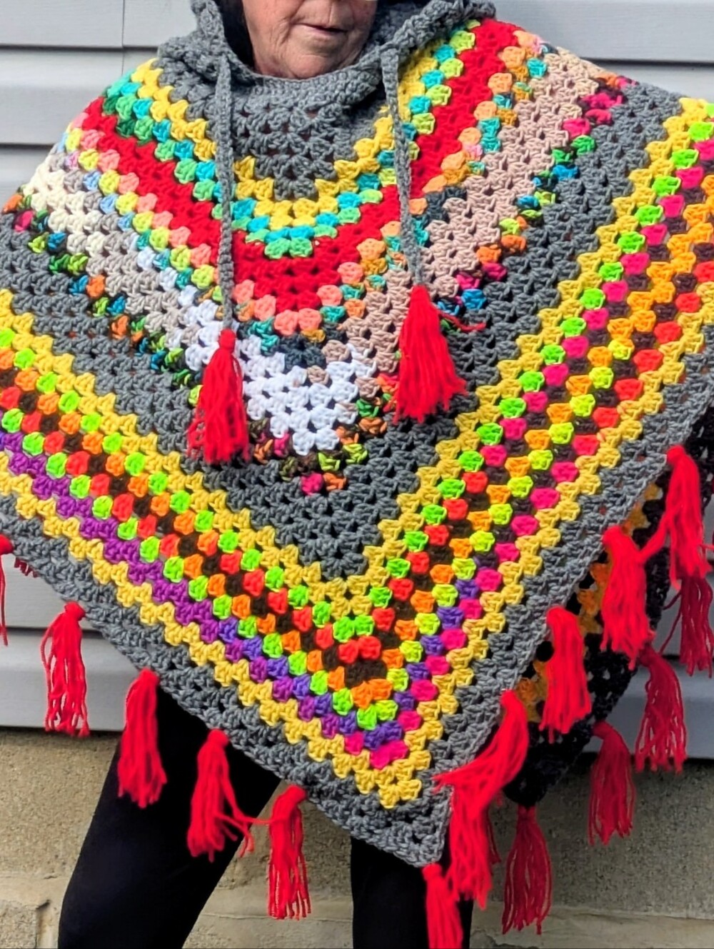 Womens Crochet Hooded Poncho with Bright Multicolor Stripes and Red Tassels